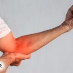 Traveler doing cubital tunnel syndrome exercises at airport - nerve glide stretch for elbow pain relief